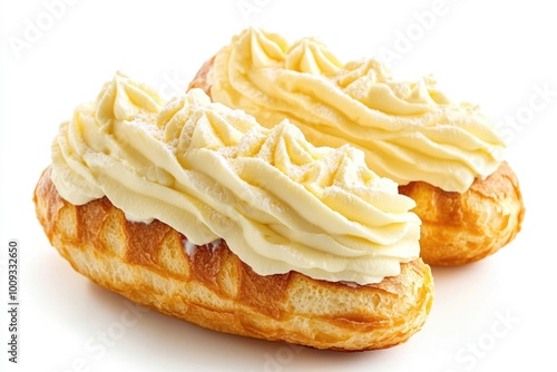 Freshly baked pastries with creamy white frosting on a clean white surface