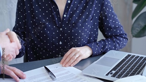 Fotografija Detailed view of two business people or lawyers signing a contract with a laptop