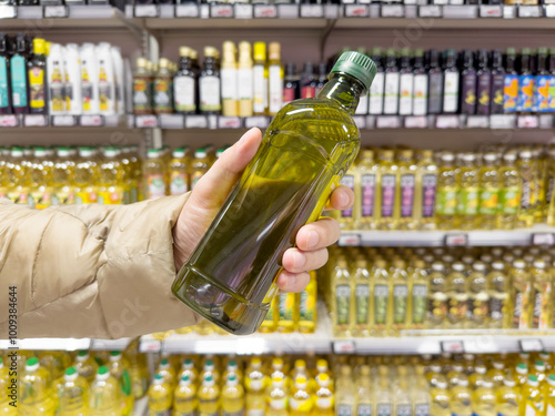 choosing olive oil, sauce, vinegar at the grocery store