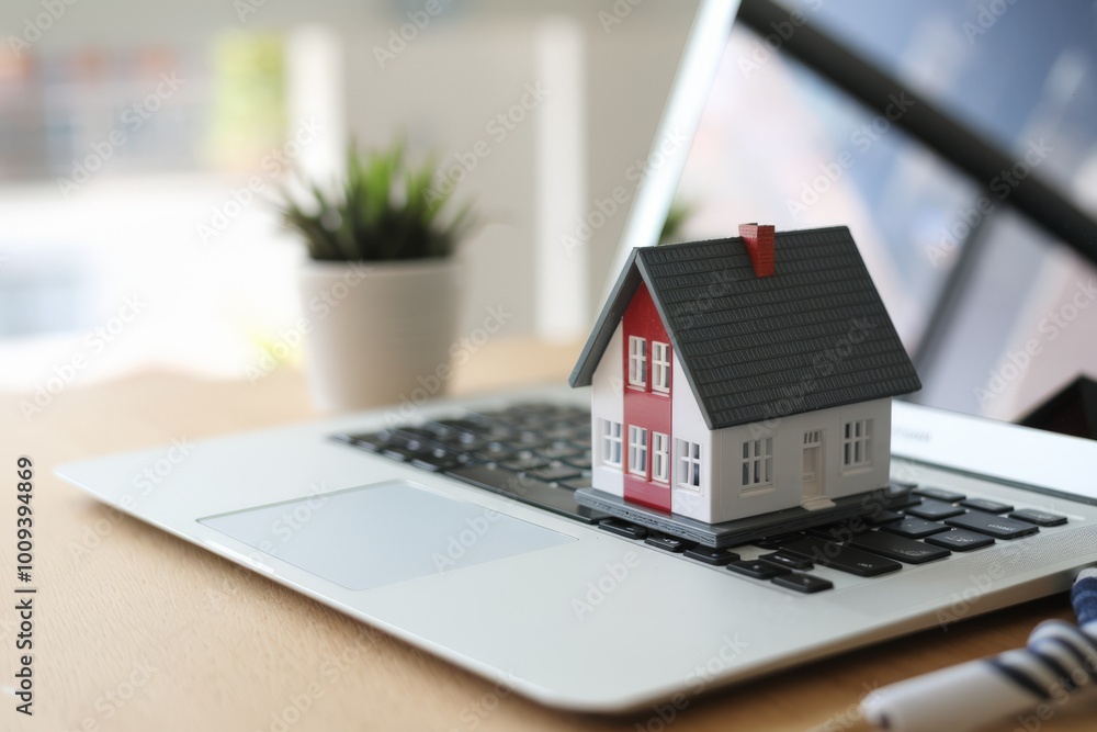Miniature house on laptop keyboard, real estate and mortgage concept. Miniature house on laptop keyboard, real estate and mortgage concept.
