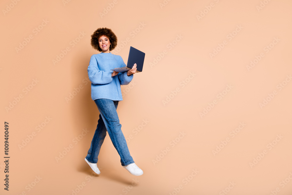 Full size photo of smart girl dressed knit sweater jeans hold laptop flying near offer empty space isolated on pastel color background Full size photo of smart girl dressed knit sweater jeans hold laptop flying near offer empty space isolated on pastel color background
