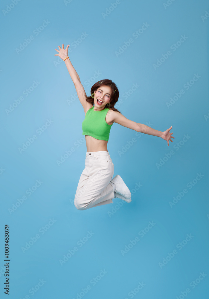 Full body length young overjoyed crazy asian girl raise hands up celebrate good shopping day advertisement offer isolated on blue background Full body length young overjoyed crazy asian girl raise hands up celebrate good shopping day advertisement offer isolated on blue background