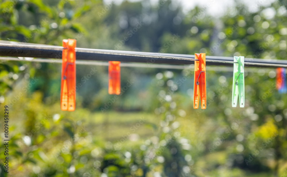Clothespins on a clothesline in summer. Dry clothes outside. Clothes on rope. Clothespins on a clothesline in summer. Dry clothes outside. Clothes on rope.