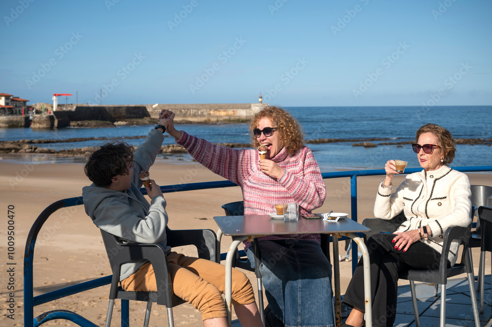 family on holiday having a coffee and an ice-cream on a beautiful terrace by the sea family on holiday having a coffee and an ice-cream on a beautiful terrace by the sea