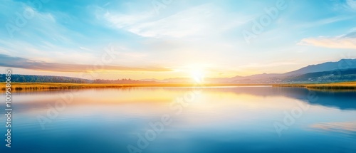  A expansive body of water lies beneath a radiant sun high in the midday sky Mountains, ranging in the distance, form an elegant backdrop