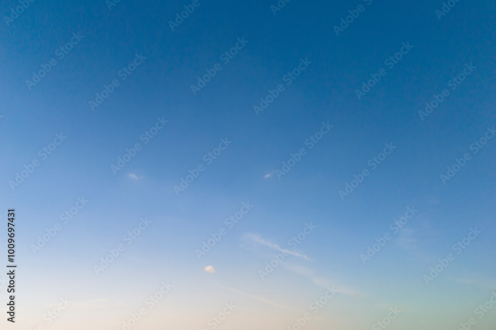 A serene blue sky at dawn, showcasing gentle clouds and soft hues. Perfect for nature themes or backgrounds. A serene blue sky at dawn, showcasing gentle clouds and soft hues. Perfect for nature themes or backgrounds.