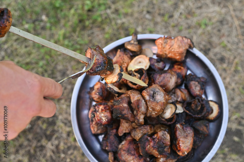 the finished kebab is removed from the skewer on a tray photo