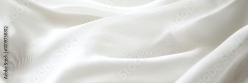 Close-up of soft flowing white fabric folds with a gentle texture, suggesting grace and purity in its beauty.