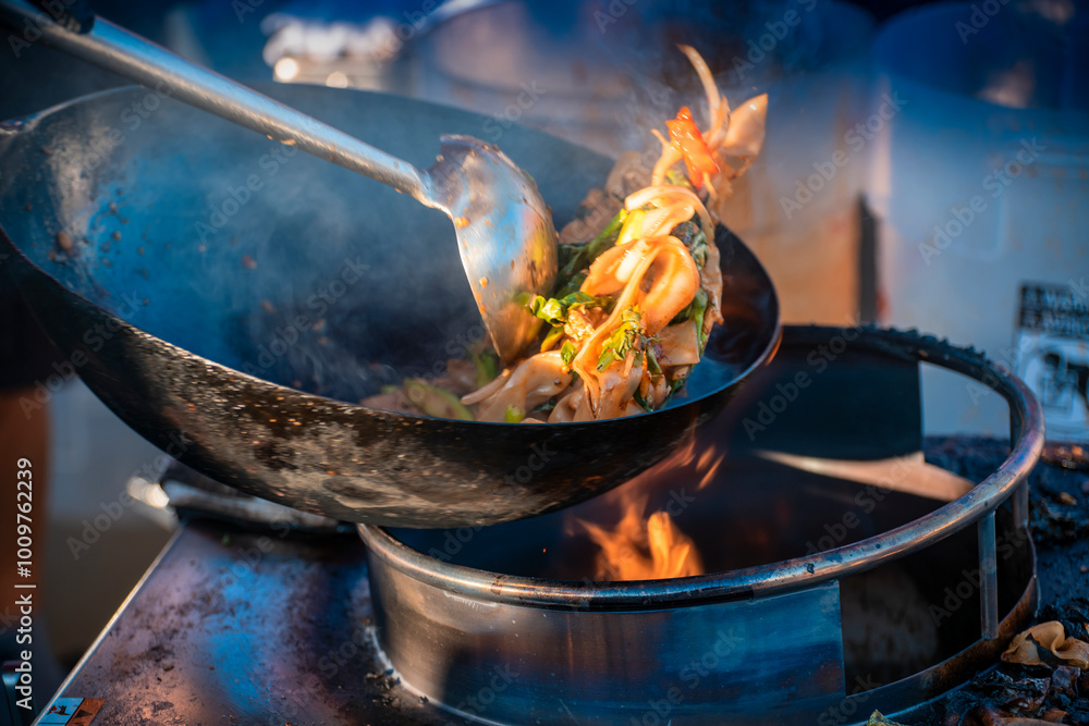 Cook flips up food in a flaming wok with vegetables and meat
Cook flips up food in a flaming wok with vegetables and meat