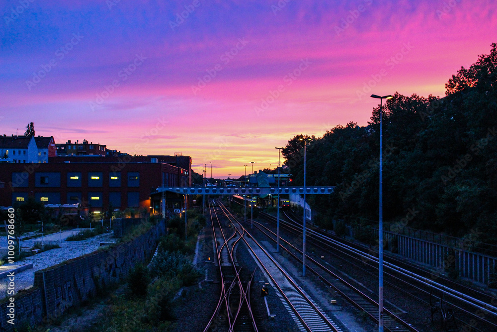 View of a colorful sunset from the bridge with S-bahn train, Neukölln Berlin View of a colorful sunset from the bridge with S-bahn train, Neukölln Berlin