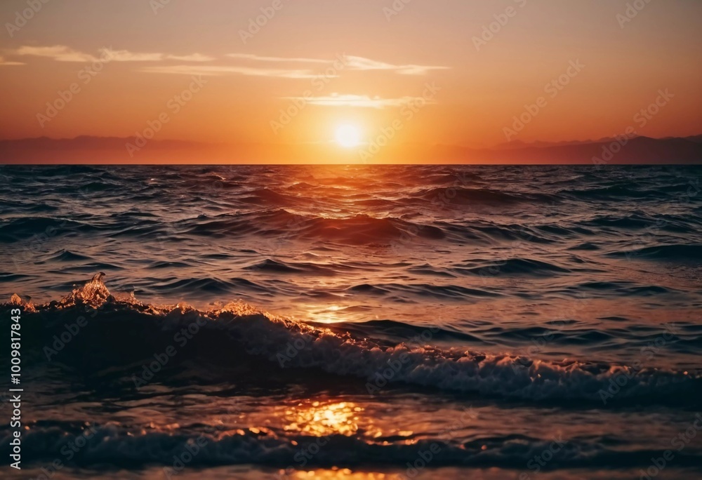 Obraz premium The warm glow of the setting sun casts golden hues over the tranquil waves of the ocean, creating a serene atmosphere by the shoreline during dusk. Sunset or sunrise at sea. Romantic landscape. AI