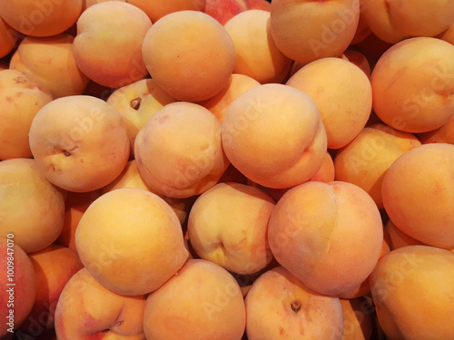 Close up of yellow natural peaches. Ripe peach fruit background. Ecological, organic and healthy food.