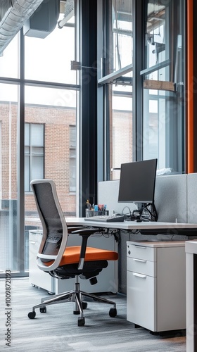 Modern office workspace with a desk, chair, and computer monitor.