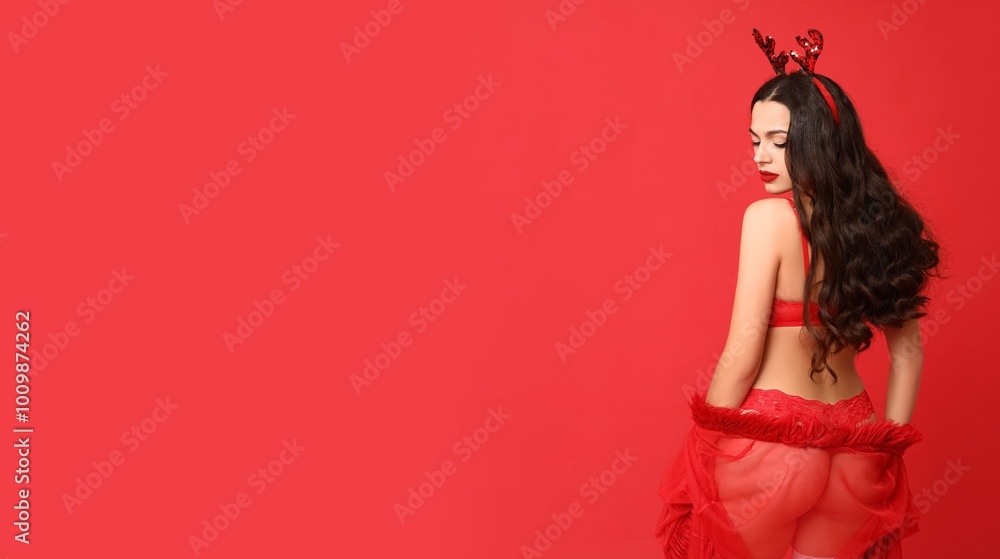 Beautiful young sexy woman in lingerie and deer horns on red background with space for text Beautiful young sexy woman in lingerie and deer horns on red background with space for text
