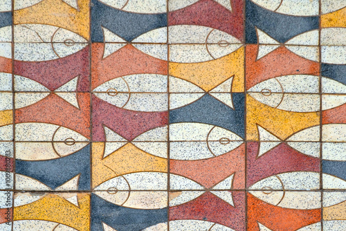 Puerto de Mogan, Gran Canaria, Spain. Colorful mosaic tiles with the image of fish on the sidewalk in the town