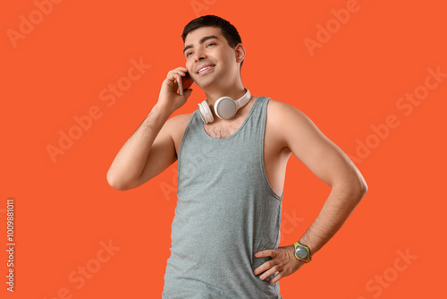 Sporty young man talking by...