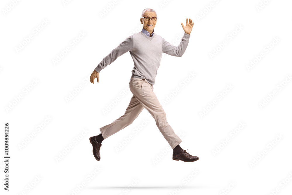 Fit mature man jumping and smiling Fit mature man jumping and smiling