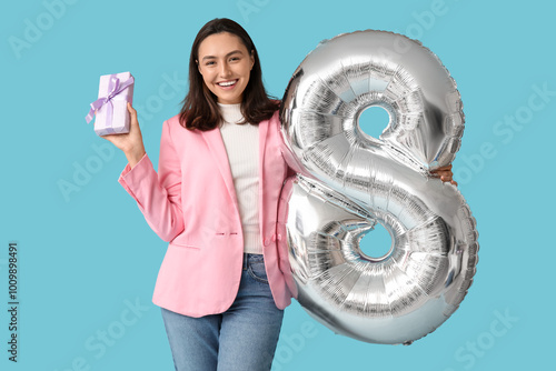 Smiling young woman holding...