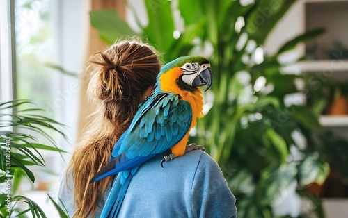 A colorful macaw perched on a woman's shoulder, surrounded by lush greenery, showcasing a bond between pet and owner. photo