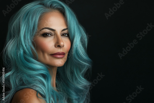 A middle-aged Arabian woman with hair styled like bold ocean waves in shades of turquoise and seafoam, set against a black background. Her high-end makeup and precise lighting bring out her graceful