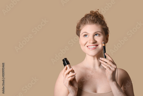 Happy young woman with bott...