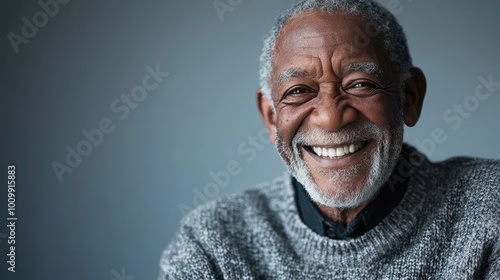 Joyful Man with Bright Smile Against Neutral Background