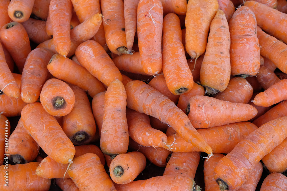 Abstract shapes, patterns and textures of piles of carrots. piles of carrots are sold in traditional markets. Carrots are a source of vitamin A Abstract shapes, patterns and textures of piles of carrots. piles of carrots are sold in traditional markets. Carrots are a source of vitamin A