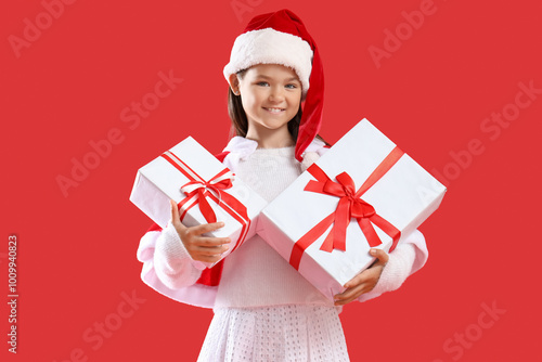Little girl in Santa hat wi...