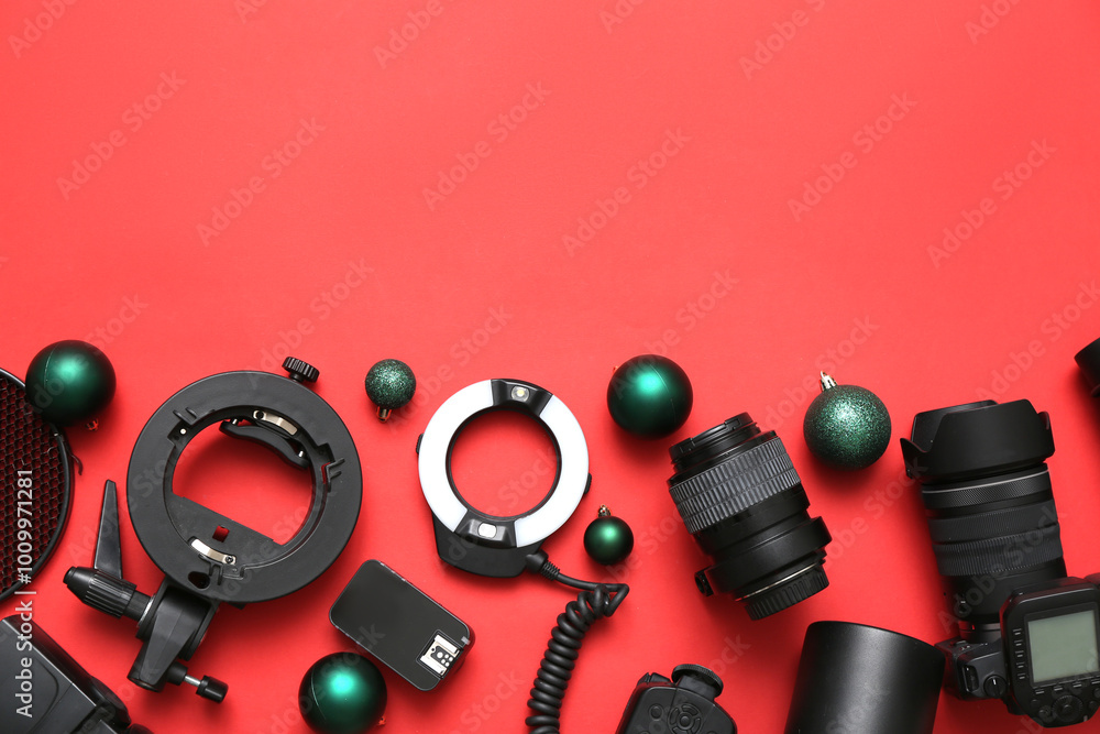 Photographer's equipment with Christmas balls on red background Photographer's equipment with Christmas balls on red background