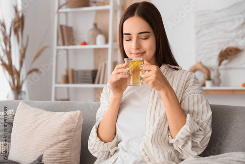 Young woman with cup of gre...