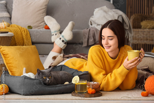 Young woman with cup of tea...