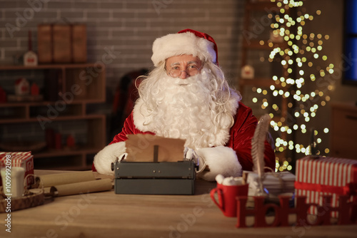 Santa Claus with vintage typewriter at home on Christmas eve