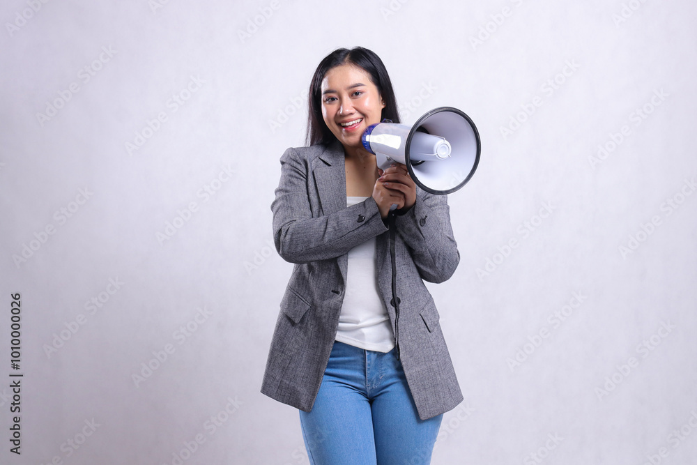 Beautiful young woman shouting formal cheerful both hands holding megaphone loudspeaker forward wearing grey suit isolated on white background. fashion, lifestyle, advertising, sale, company concept Beautiful young woman shouting formal cheerful both hands holding megaphone loudspeaker forward wearing grey suit isolated on white background. fashion, lifestyle, advertising, sale, company concept