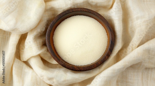 Birch sugar, xylitol-based sweetener in a wooden bowl on a linen cloth, natural food photo