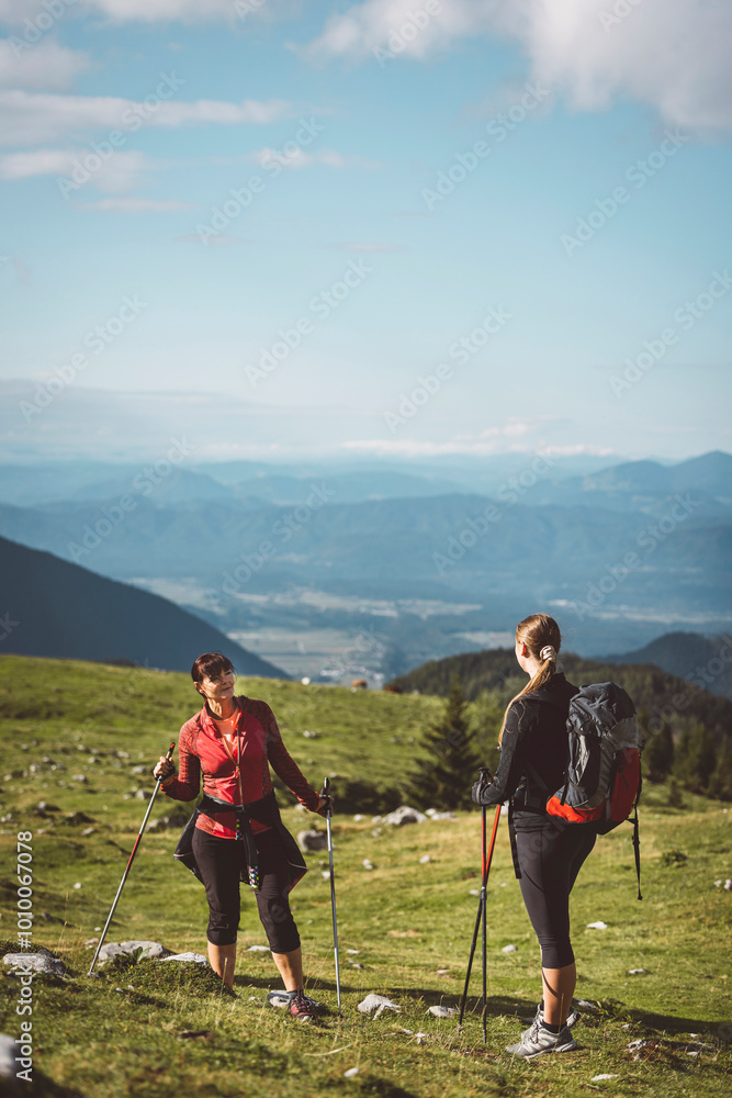 Caucasian women, friends, hiking in their free time spending time in nature. Woman on an autumn hike in the Alps. Caucasian women, friends, hiking in their free time spending time in nature. Woman on an autumn hike in the Alps.