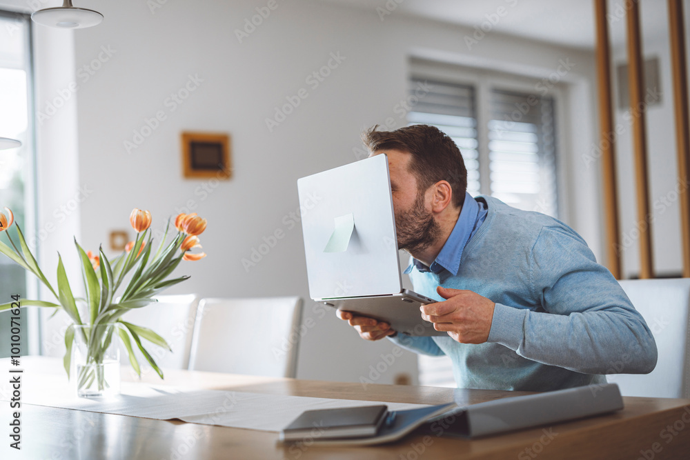 Excited man full of energy sitting behind laptop with big smile on his face. Overly happy person looking at the laptop. Business success. Excited man full of energy sitting behind laptop with big smile on his face. Overly happy person looking at the laptop. Business success.