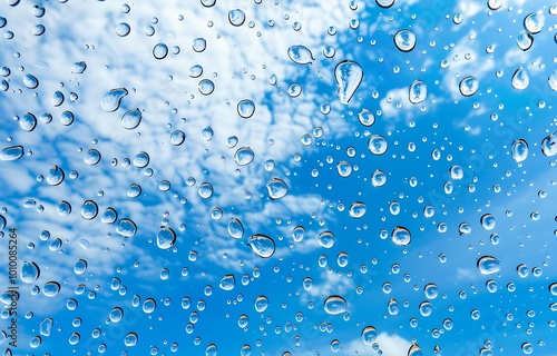 Water droplets on glass with a clear blue sky in the background.