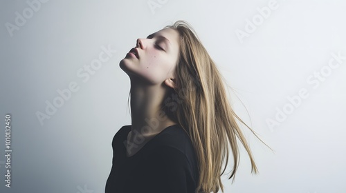 Young woman with long blonde hair looking up. photo