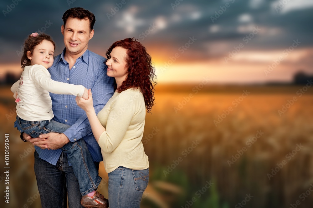 Fototapeta premium happy family walks with children in summer field