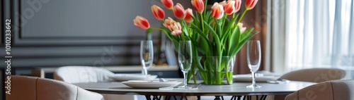 Stylish dining room interior with comfortable furniture and beautiful tulips