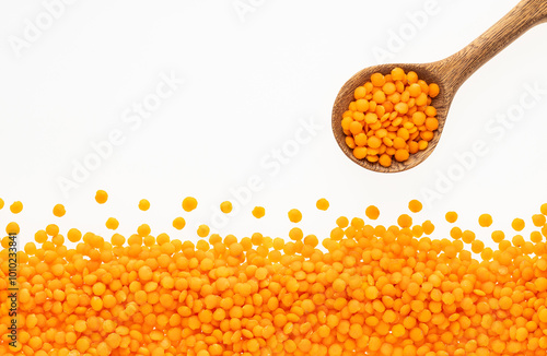 Lens culinaris - Spoon with raw red lentils. photo