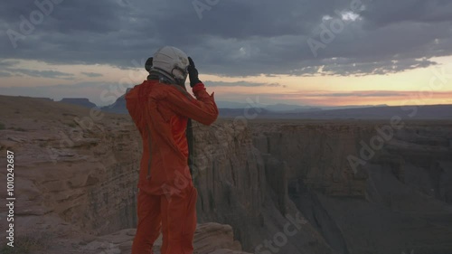 Exploring the majestic desert crater at sunset in astronaut gear