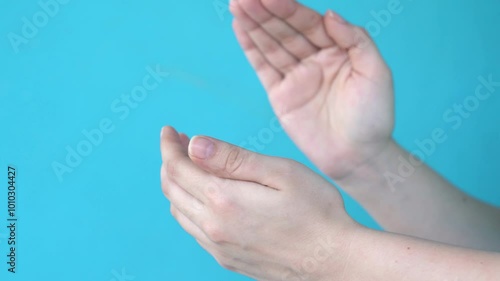 White Hands Clapping Against Blue Background in Close-Up