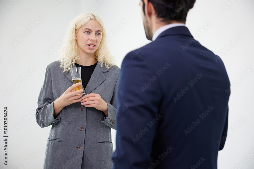 businesswoman talking with businessman and holding a glasses of beer in the office businesswoman talking with businessman and holding a glasses of beer in the office