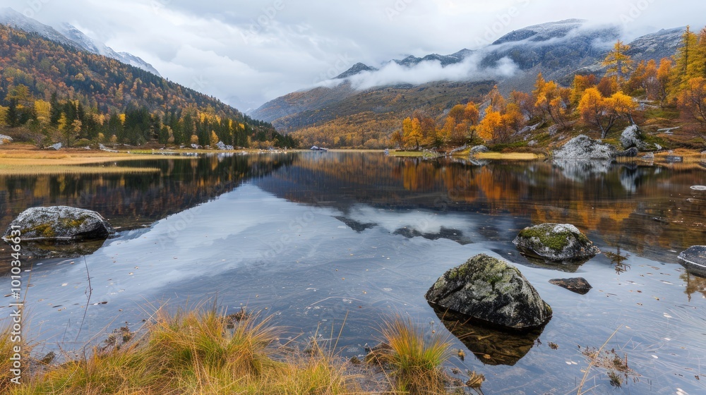 Fototapeta premium Autumnal Mountain Lake with Cloudy Sky and Reflection