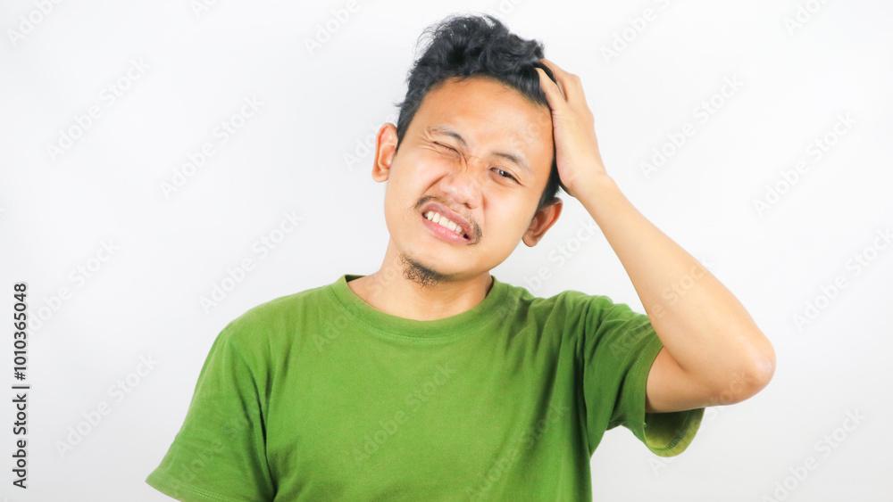 A man is dizzy and holding his head standing on a white background A man is dizzy and holding his head standing on a white background
