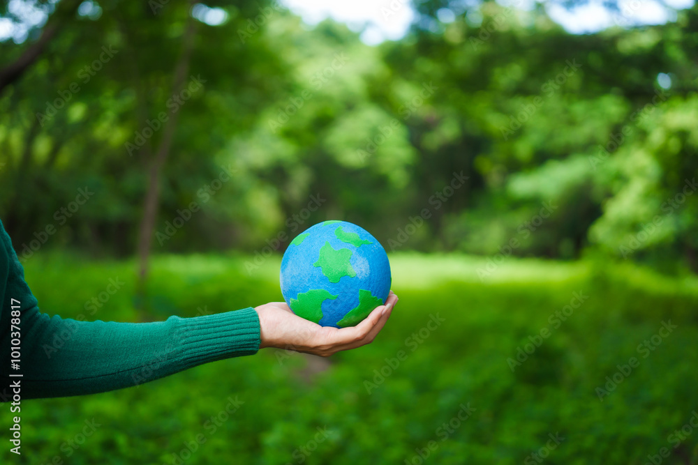 An Asian woman holds a globe in a green forest,symbolizing the importance of preserving nature.emphasizes balance between humans, natural resources,sustainable environmental development protect An Asian woman holds a globe in a green forest,symbolizing the importance of preserving nature.emphasizes balance between humans, natural resources,sustainable environmental development protect