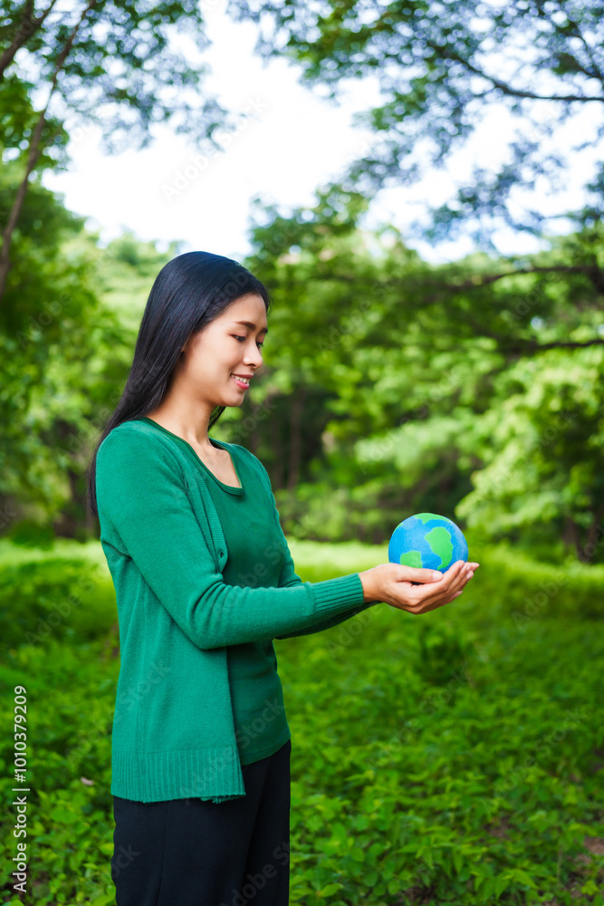 An Asian woman holds a globe in a green forest,symbolizing the importance of preserving nature.emphasizes balance between humans, natural resources,sustainable environmental development protect An Asian woman holds a globe in a green forest,symbolizing the importance of preserving nature.emphasizes balance between humans, natural resources,sustainable environmental development protect