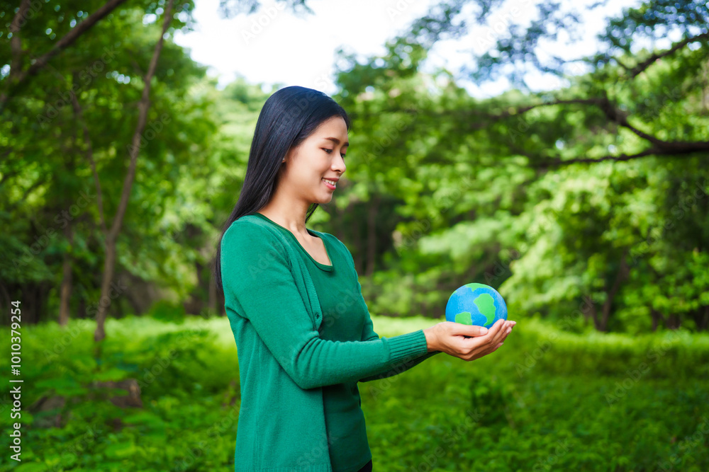 An Asian woman holds a globe in a green forest,symbolizing the importance of preserving nature.emphasizes balance between humans, natural resources,sustainable environmental development protect An Asian woman holds a globe in a green forest,symbolizing the importance of preserving nature.emphasizes balance between humans, natural resources,sustainable environmental development protect