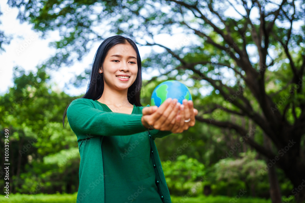 An Asian woman holds a globe in a green forest,symbolizing the importance of preserving nature.emphasizes balance between humans, natural resources,sustainable environmental development protect An Asian woman holds a globe in a green forest,symbolizing the importance of preserving nature.emphasizes balance between humans, natural resources,sustainable environmental development protect